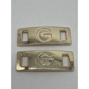 Guess Gold-Tone Emblem Shoe Lace Accessories Set Of 2 Curved Rectangular Design